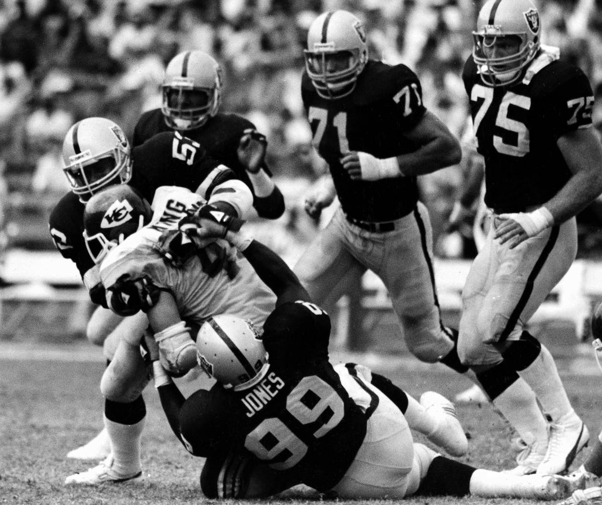 Kansas City Chiefs running back Bruce King is pulled down for no gain by Los Angeles Raiders Ro ...