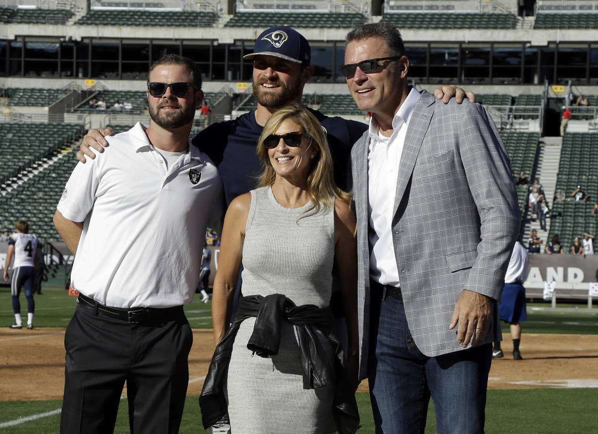 Former NFL player Howie Long, right, poses for photos with his wife Diane Addonizio, center, an ...