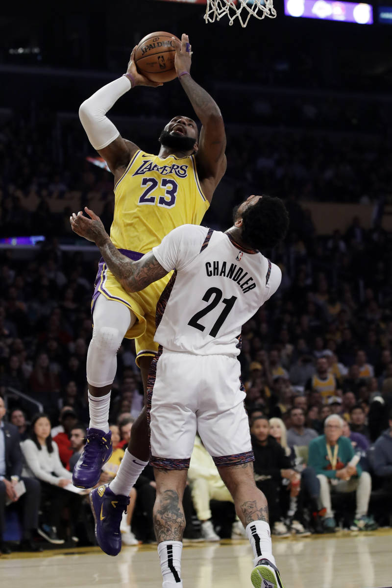 Los Angeles Lakers' LeBron James (23) shoots over Brooklyn Nets' Wilson Chandler (21) during th ...