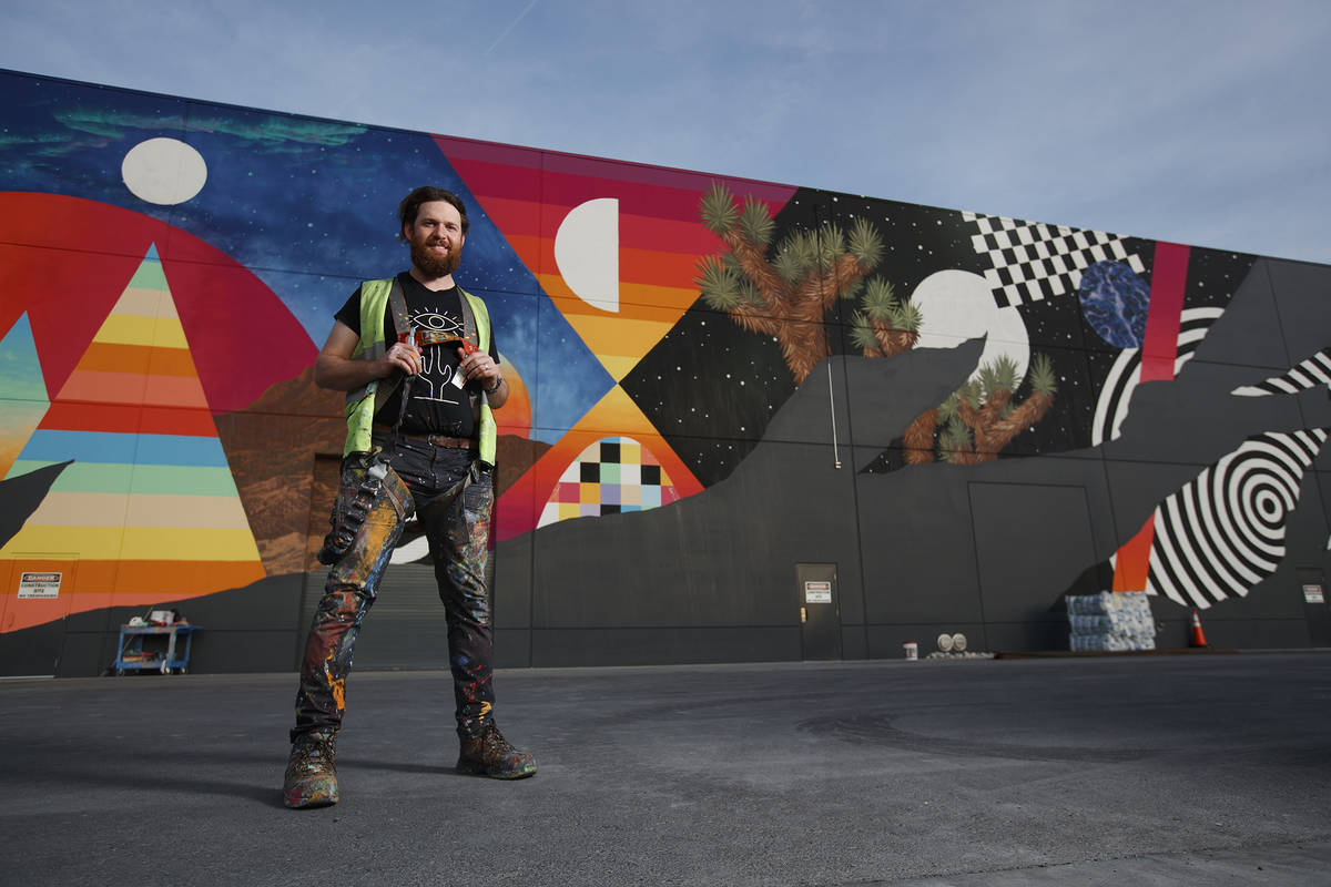 Eric Vozzola and his mural at Area 15 in Las Vegas. ( Kate Russell, Courtesy of Meow Wolf)