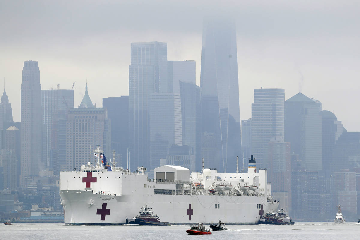 The Navy hospital ship USNS Comfort passes lower Manhattan on its way to docking in New York, M ...