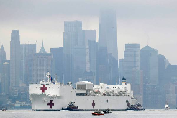 The Navy hospital ship USNS Comfort passes lower Manhattan on its way to docking in New York, M ...