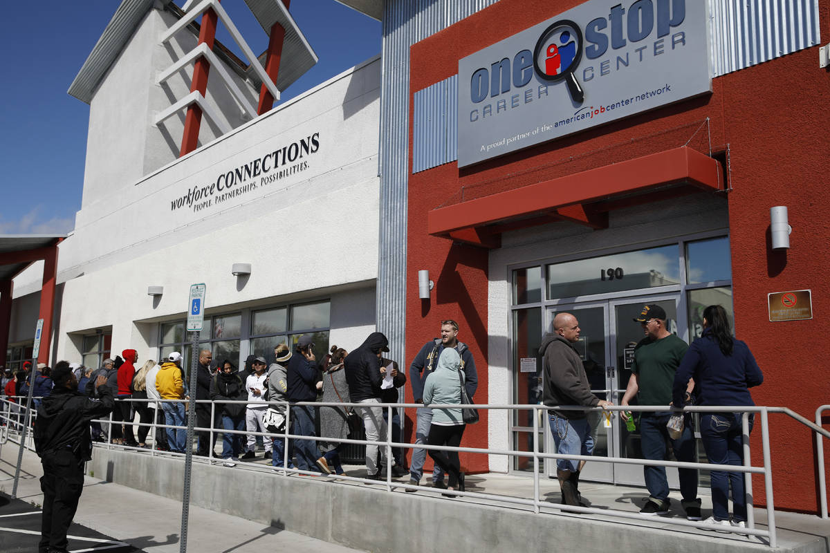 In a March 17, 2020 file photo, people wait in line for help with unemployment benefits at the ...