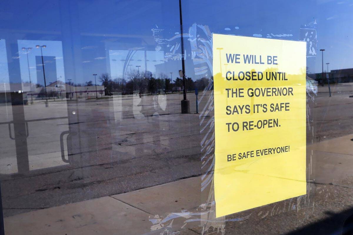 A closed sign is shown at Romeo & Juliet Furniture and Appliances with an empty parking lot ...