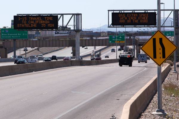 A Nevada Department of Transportation sign sends a message of traffic safety and COVID-19 socia ...