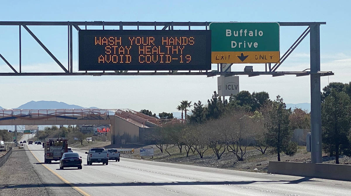A digital messaging sign on Summerlin Parkway displays a COVID-19 public service announcement, ...