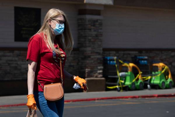 Local teacher Larissa Ellison wears a mask and gloves after getting groceries at Smith's Food a ...