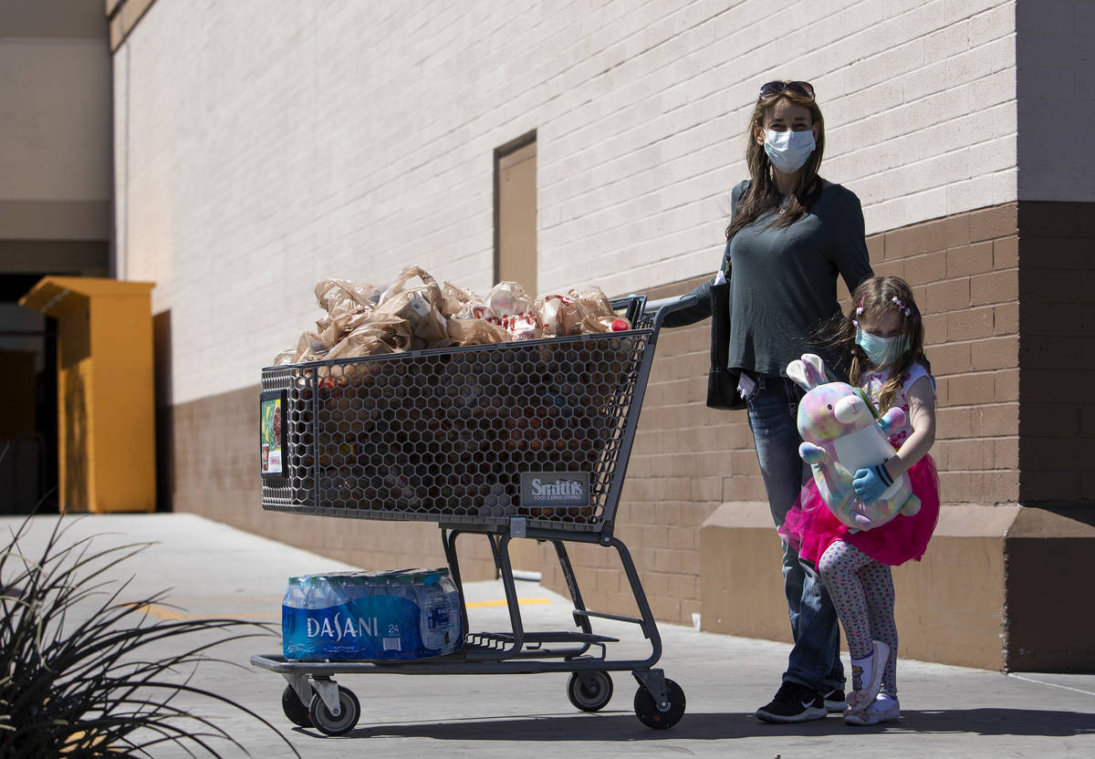 Leslie Attisani and her daughter Lily Attisani wore masks and gloves to their grocery store tri ...