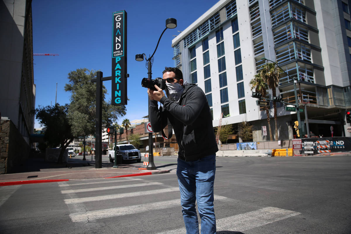 Advertising photographer Greg Anderson takes a photo in downtown Las Vegas wearing a bandana to ...