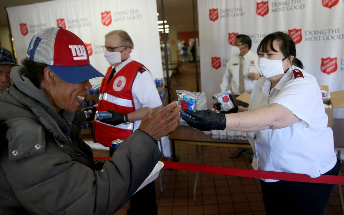 The Salvation Army Lieutenant Heather Baze hands out pandemic kits to the homeless in North Las ...