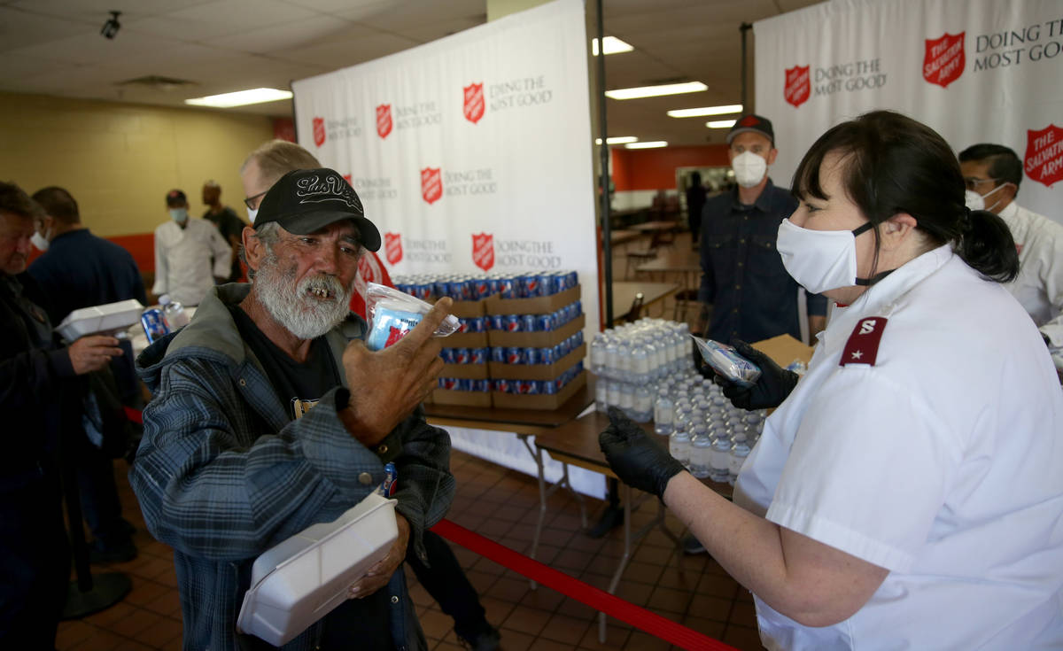 The Salvation Army Lieutenant Heather Baze hands out pandemic kits to the homeless in North Las ...