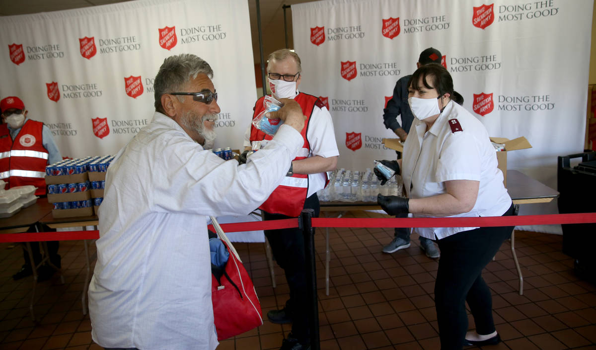 The Salvation Army Lieutenant Heather Baze gives a pandemic kit to Martin Borunda, 62, in Nort ...