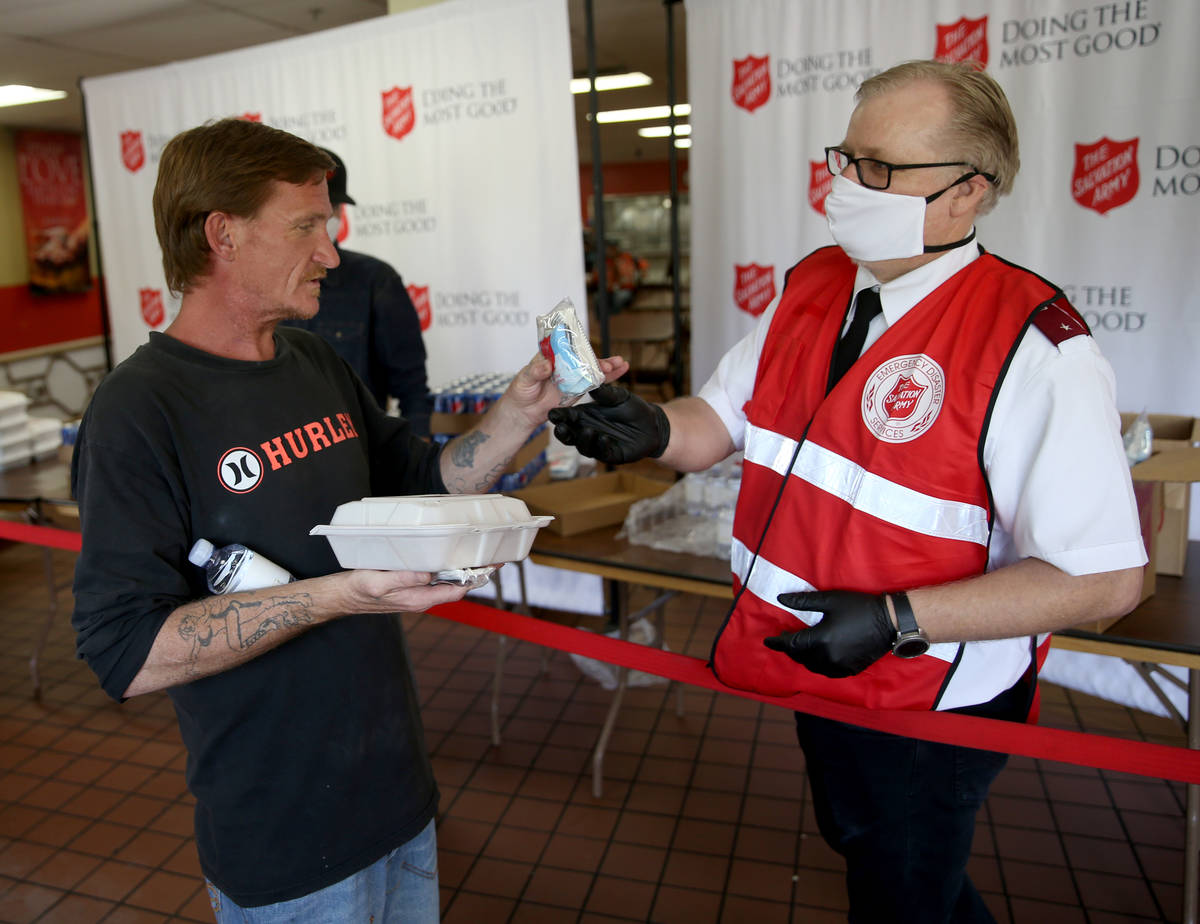 The Salvation Army Lieutenant Ty Baze gives a pandemic kit to Dale Davis, 42, in North Las Vega ...