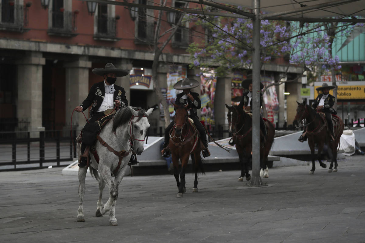 Mexican police dressed as charros patrol the popular Garibaldi square now empty of visitors in ...
