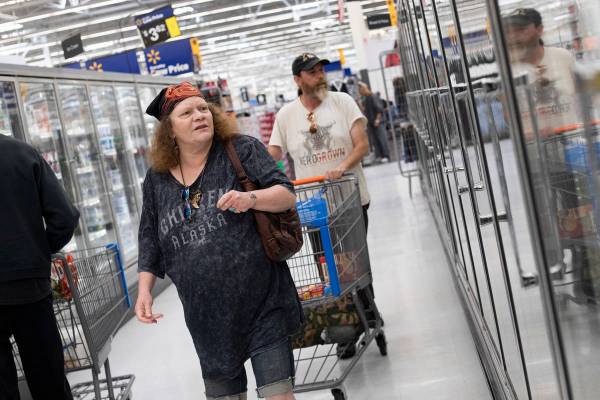 Debbie Holmgren and Todd Henke shop for food in the frozen section of Walmart on Saturday, Apri ...