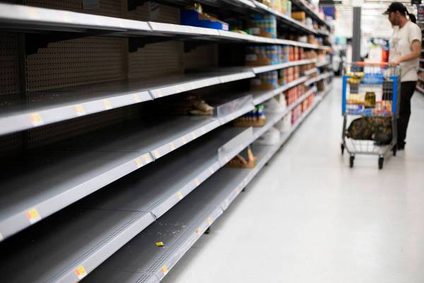 The rice and beans sections at Walmart are almost empty as Todd Holmgren shops for groceries on ...
