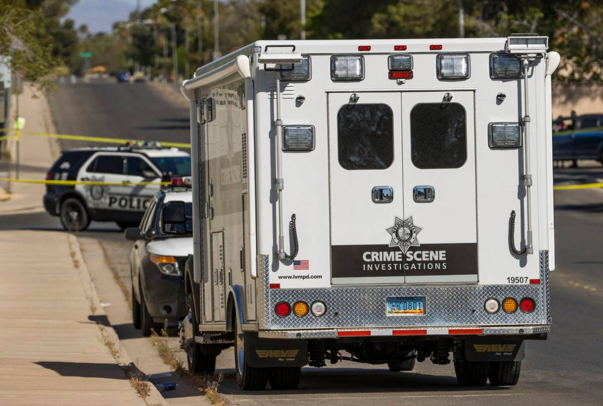 A Crime Scene Investigations vehicle is parked on the street as the Las Vegas police are on the ...