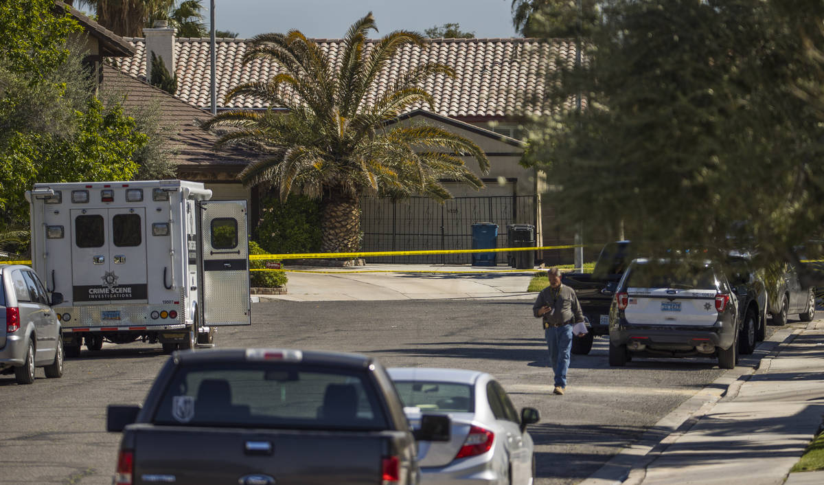 A Crime Scene Investigations vehicle, left, is parked on the street as the Las Vegas police are ...