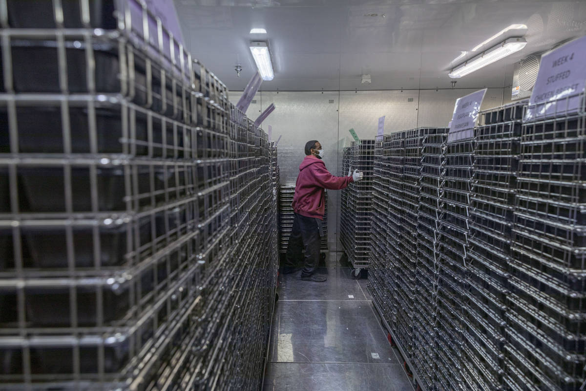 James Smith adds to the freezer containing 15,000 meals to be delivered through Meals on Wheels ...