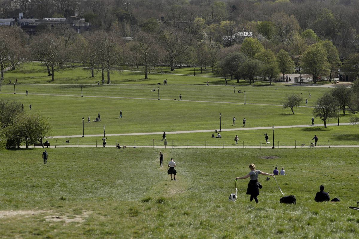 People spread out as they observe social distancing on Primrose Hill in London, as London's par ...