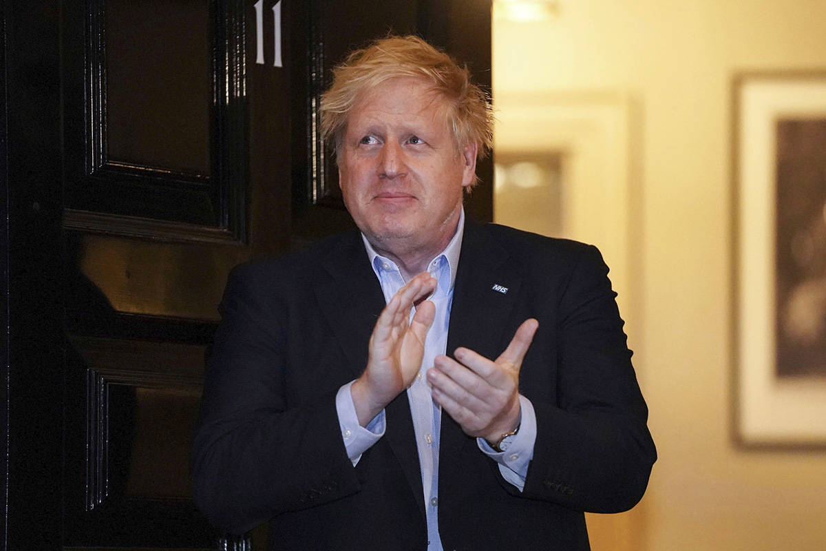 In this handout photo provided by 10 Downing Street, Britain's Prime Minister Boris Johnson cla ...