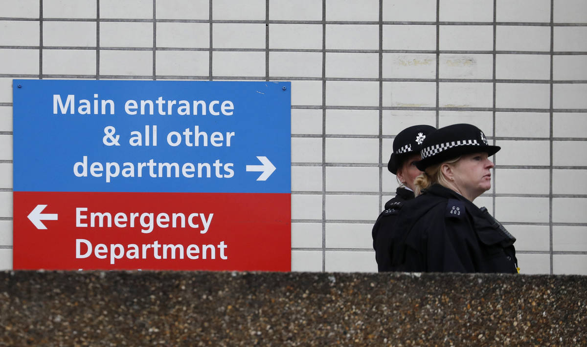Police officers patrol outside a hospital where it is believed that Britain's Prime Minister Bo ...