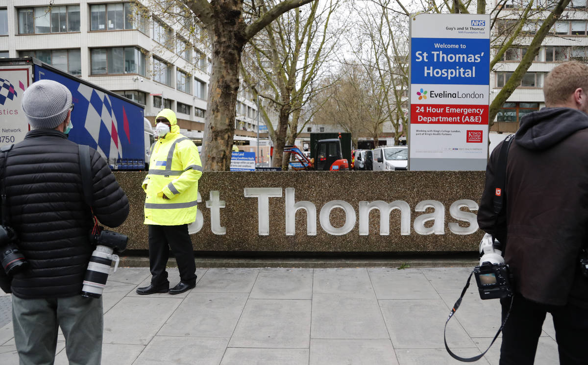 Media wait outside a hospital where it is believed that Britain's Prime Minister Boris Johnson ...