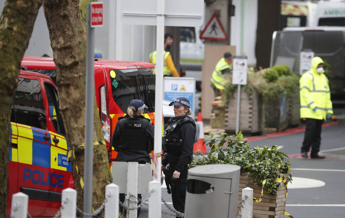 Police officers stand guard outside a hospital where it is believed that Britain's Prime Minist ...