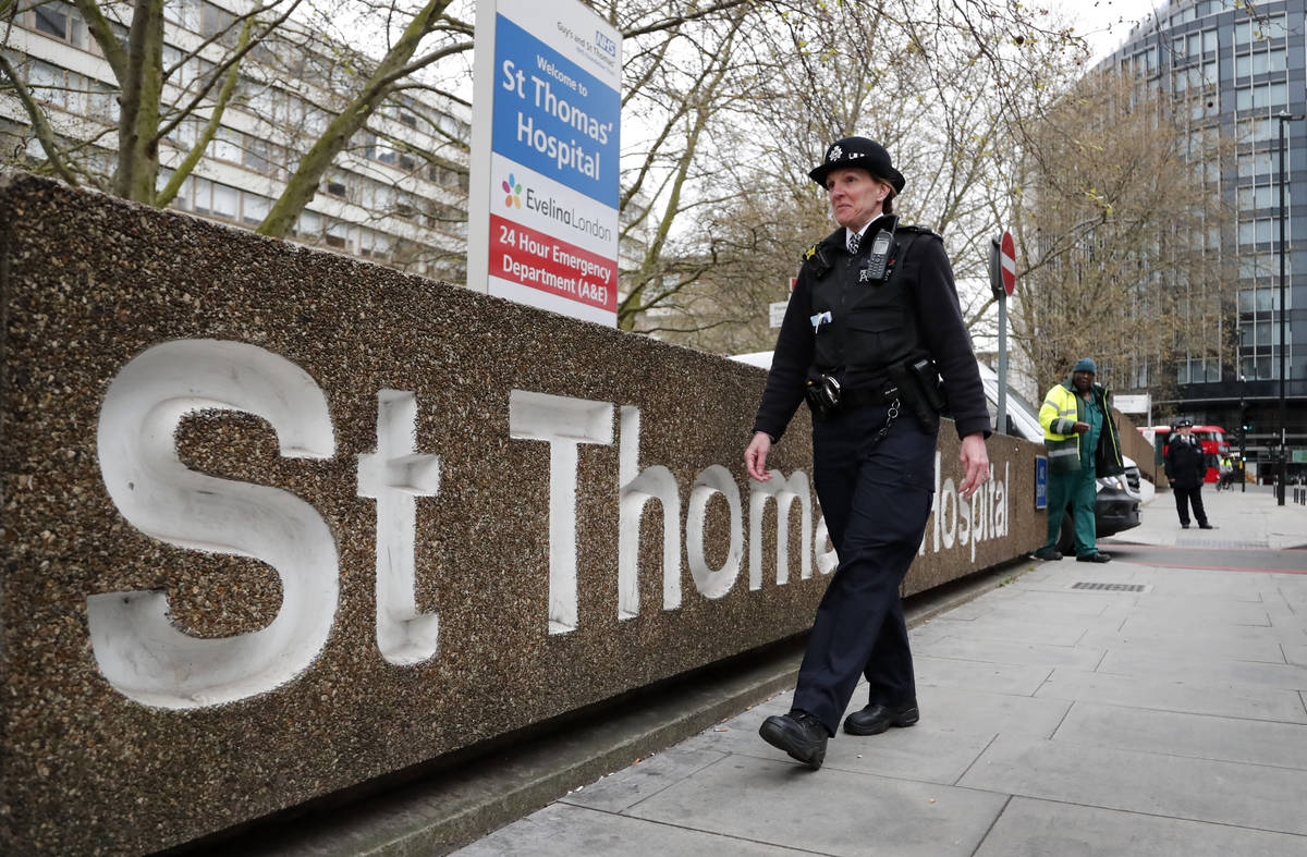 A police officer patrols outside a hospital where it is believed but not confirmed that Britain ...