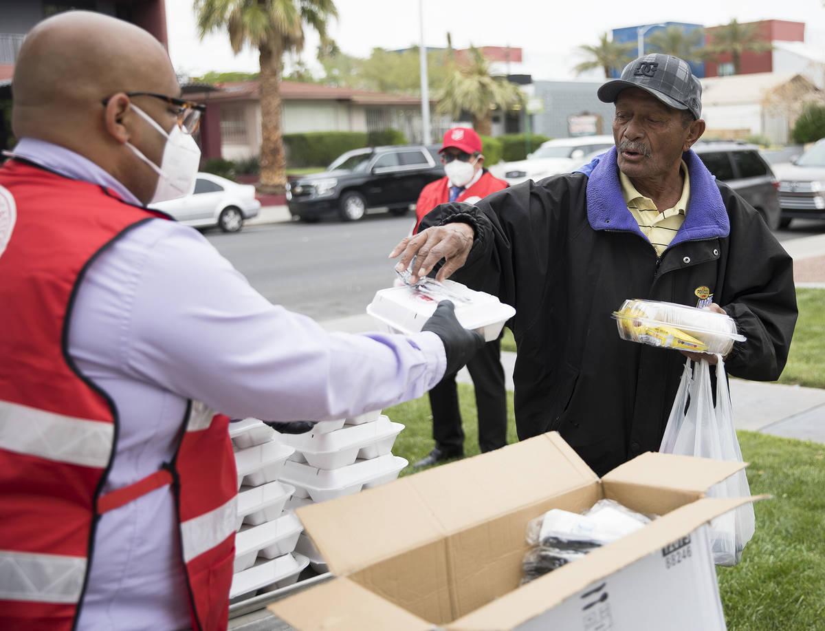 Jawan Mullen, vocational and residential services coordinator for the Salvation Army, hands out ...