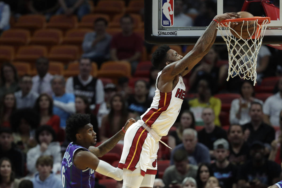 Miami Heat forward Derrick Jones Jr. dunks the ball against Charlotte Hornets forward Jalen McD ...