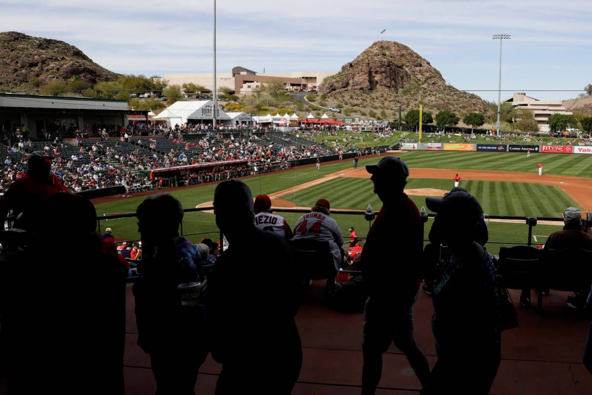 Fans watch a spring training baseball game between the Los Angeles Angels and the San Diego Pad ...