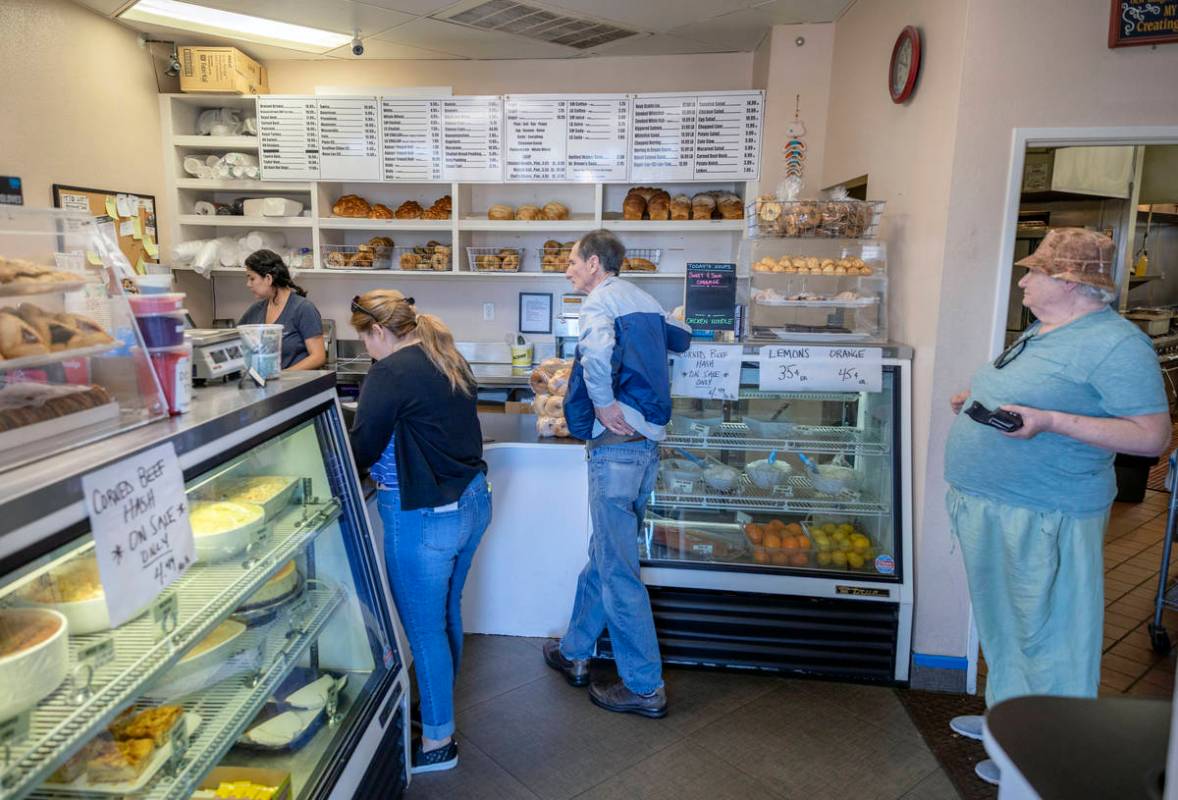 Customers of Weiss Deli and Bakery wait to place a takeout order, in Las Vegas on Friday, April ...