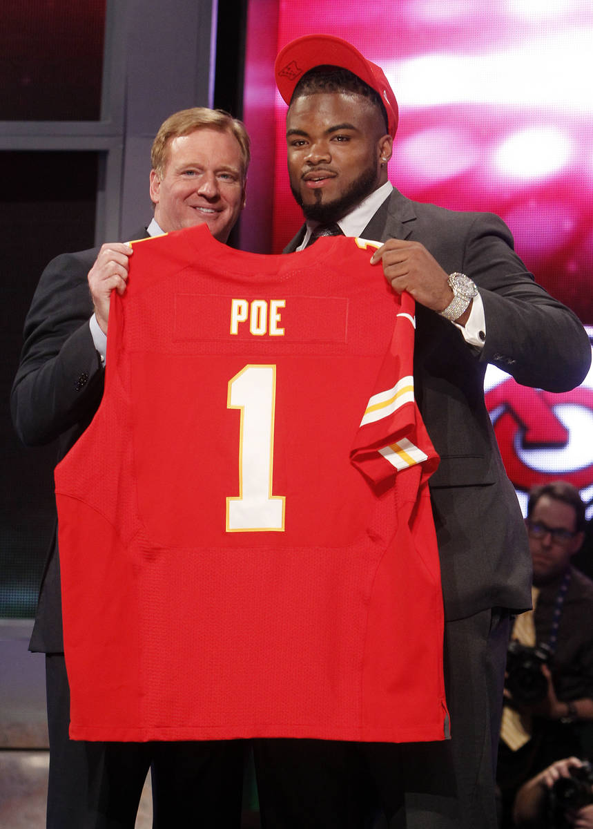 Memphis defensive tackle Dontari Poe, right, poses for photographs with NFL Commissioner Roger ...