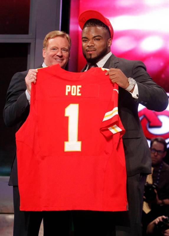 Memphis defensive tackle Dontari Poe, right, poses for photographs with NFL Commissioner Roger ...