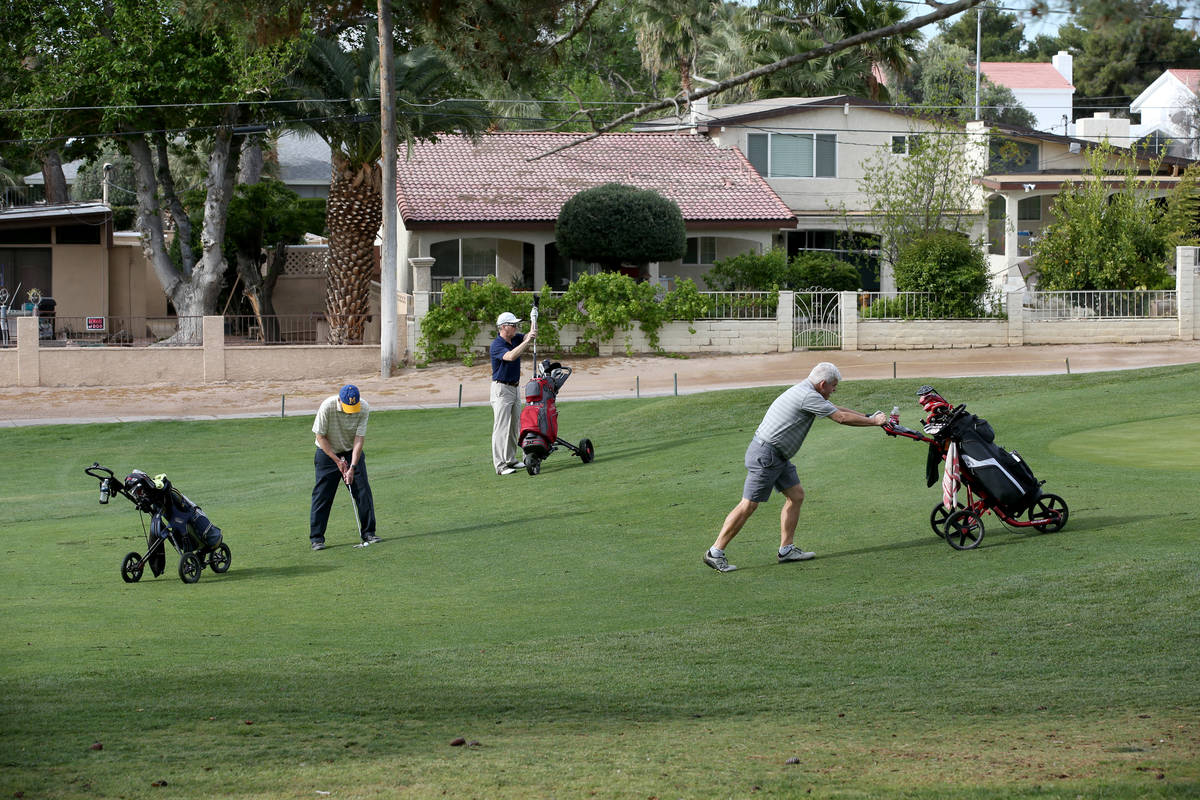 Golfers at Las Vegas National Golf Club Wednesday, April 8, 2020. Golf courses have closed club ...