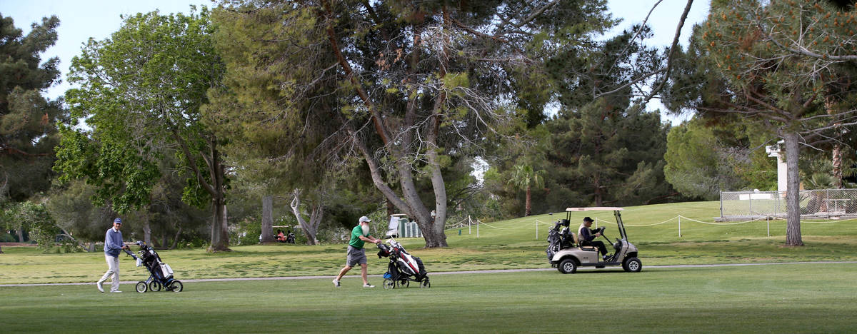 Golfers at Las Vegas National Golf Club Wednesday, April 8, 2020. Golf courses have closed club ...