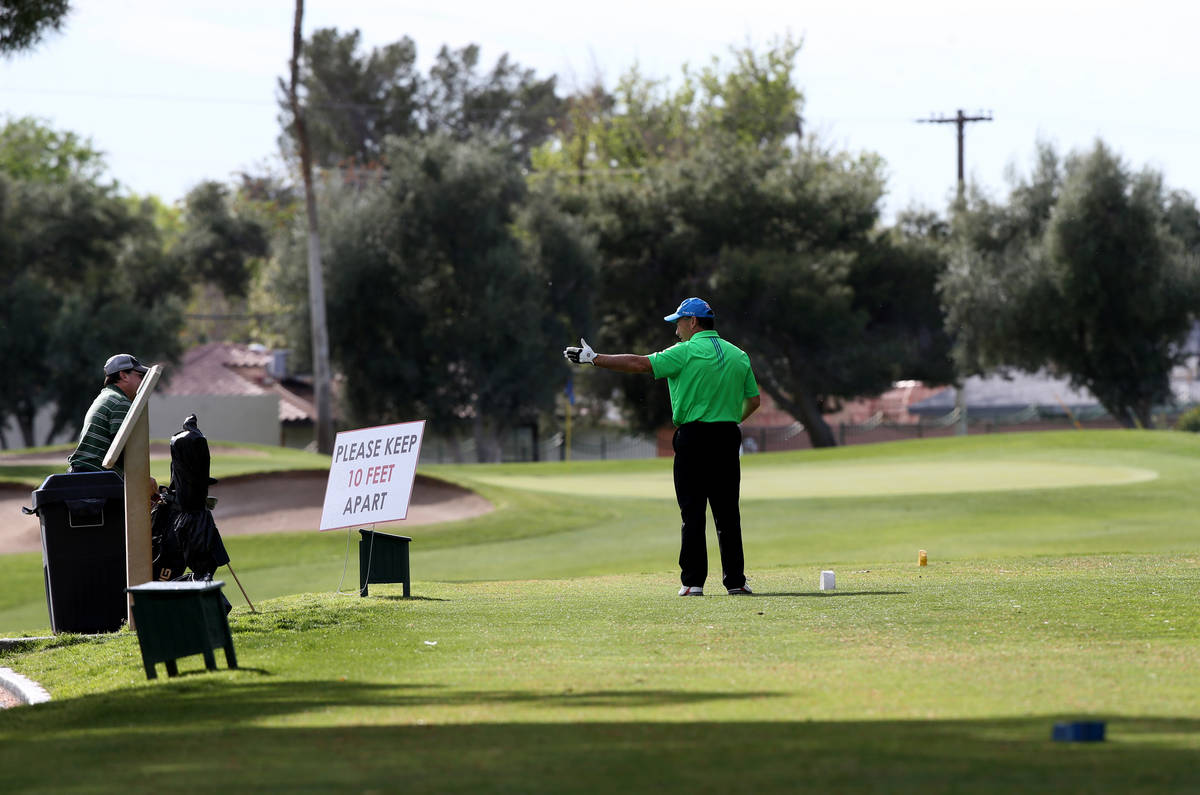 Golfers at Las Vegas National Golf Club Wednesday, April 8, 2020. Golf courses have closed club ...