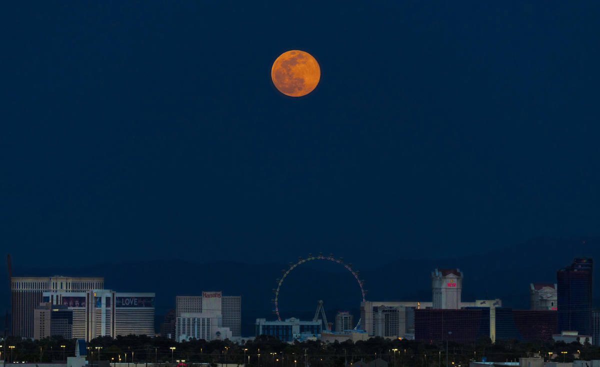 A pink supermoon rises over the Las Vegas Strip on Tuesday, April 7, 2020. (Benjamin Hager/Las ...