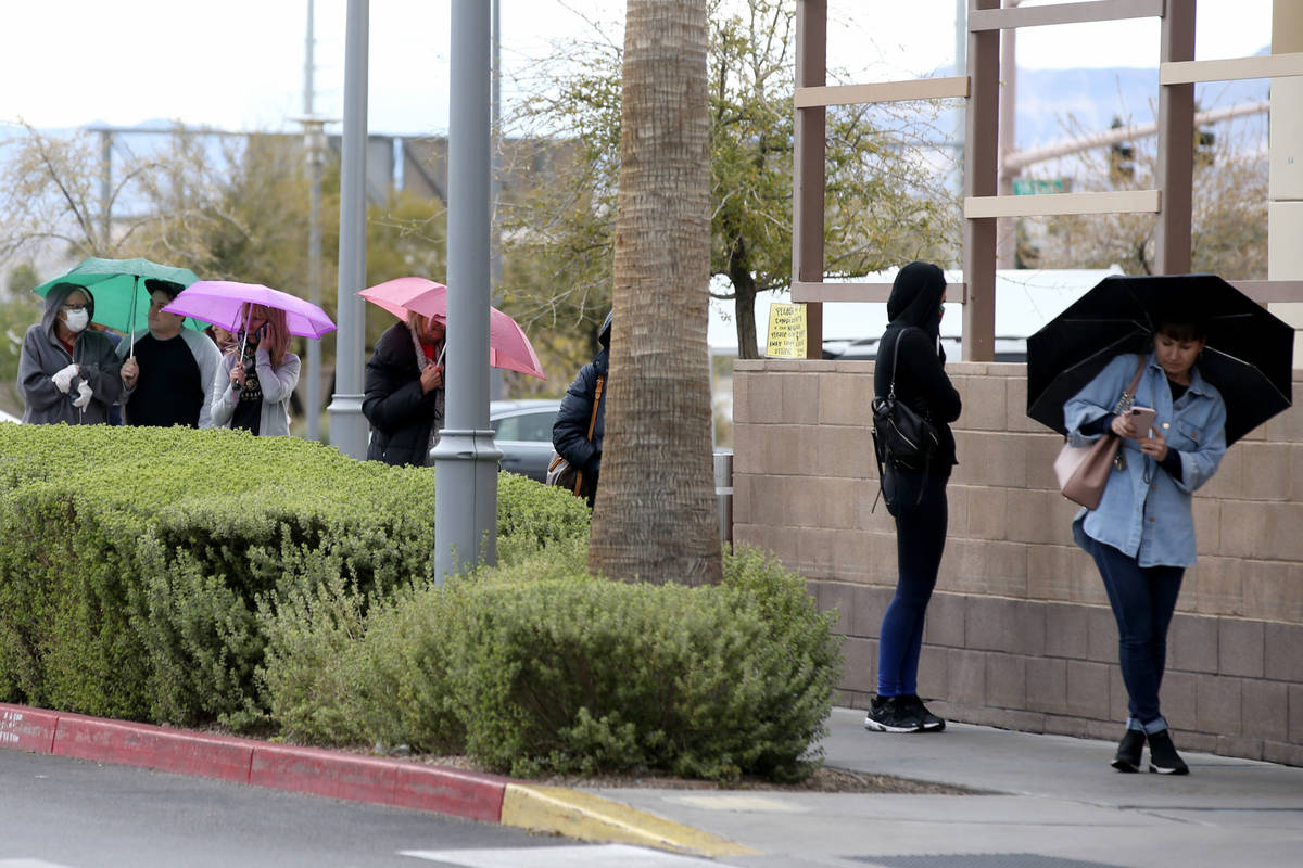 Shoppers line up in a light rain at Trader Joe's in Downton Summerlin in Las Vegas Wednesday, A ...