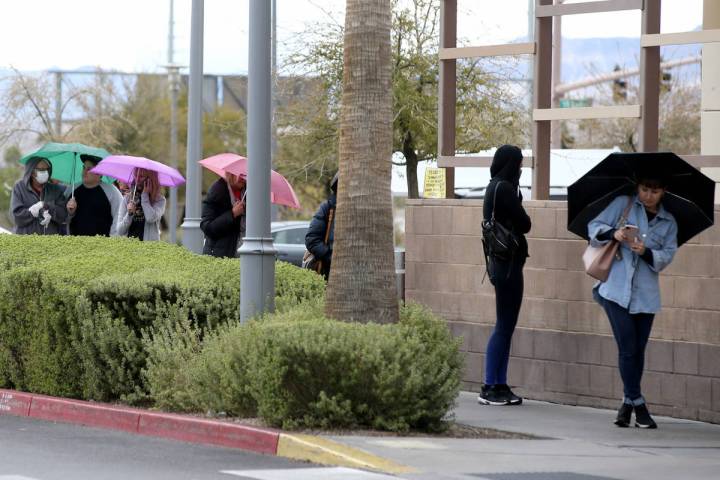 Shoppers line up in a light rain at Trader Joe's in Downton Summerlin in Las Vegas Wednesday, A ...