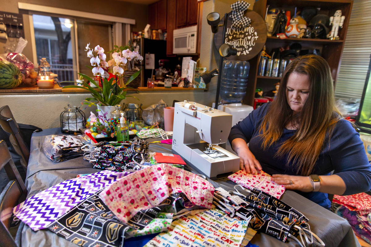 Chrissy Burley-Evans spends the evenings sewing more decorative cotton face masks as part of he ...