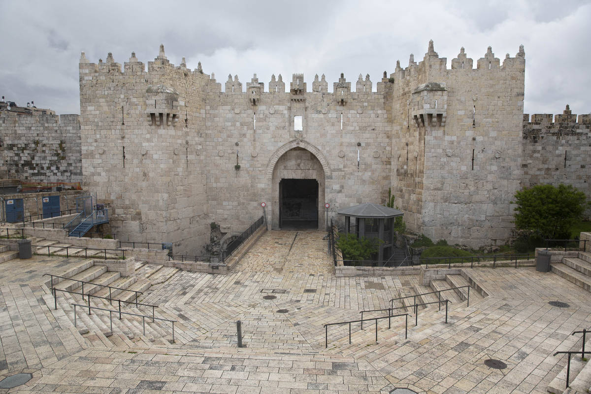 The Damascus Gate sits empty in Jerusalem's old city, Friday, April 10, 2020. Christians are co ...