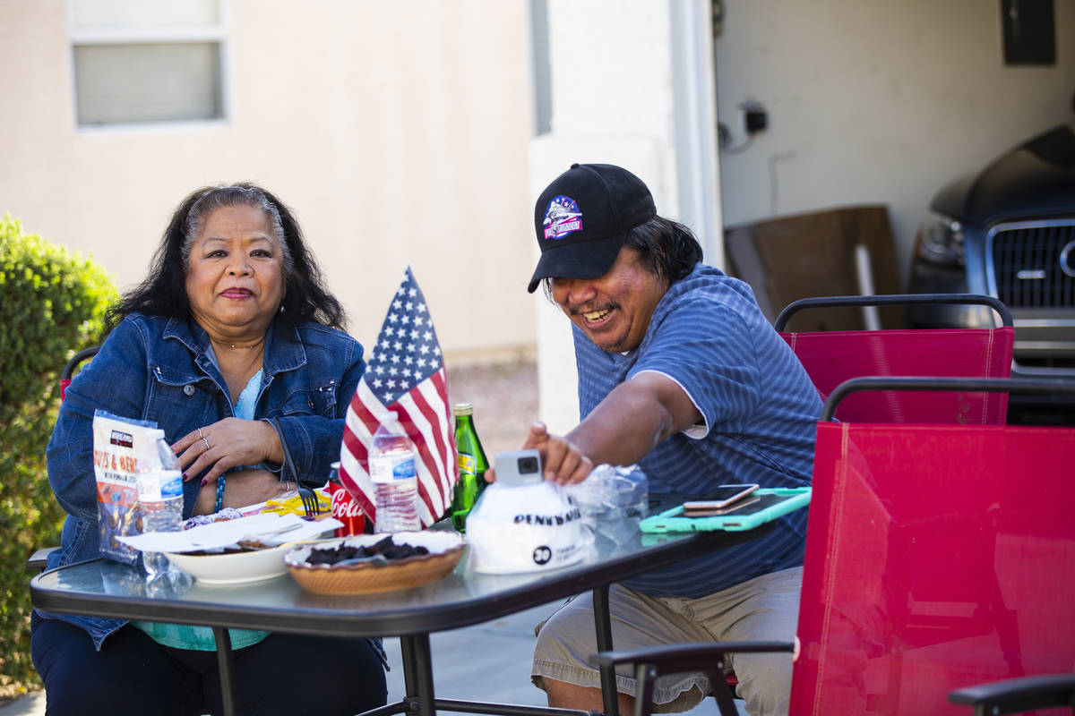 Angelina Eusebio, left, and Noel Eusebio enjoy the weather outside of their home while particip ...