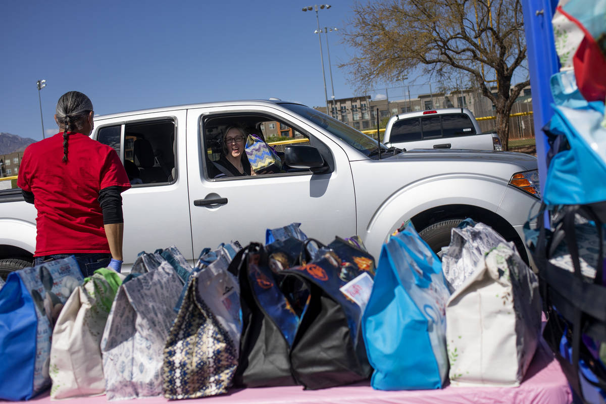 A family picks up Easter baskets in a drive through at Mountain Ridge Park on Saturday, April 1 ...