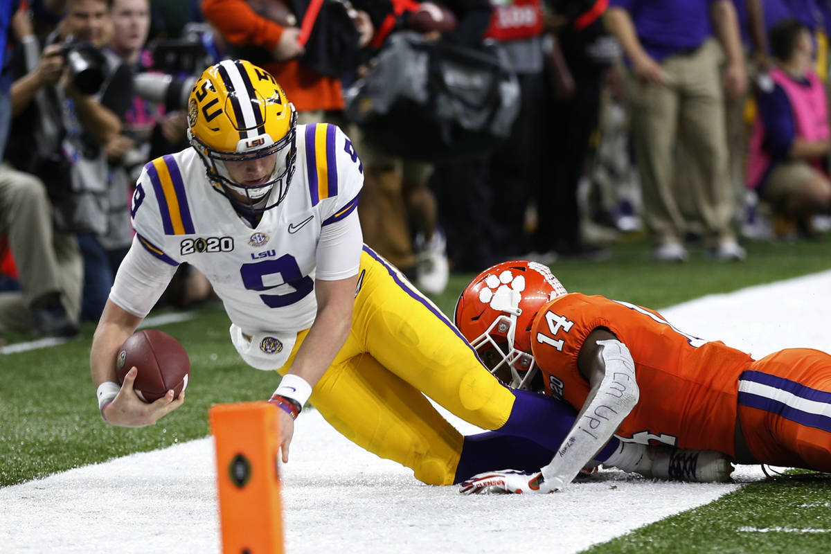 LSU quarterback Joe Burrow is tackled by LSU defensive back Maurice Hampton Jr. during the firs ...