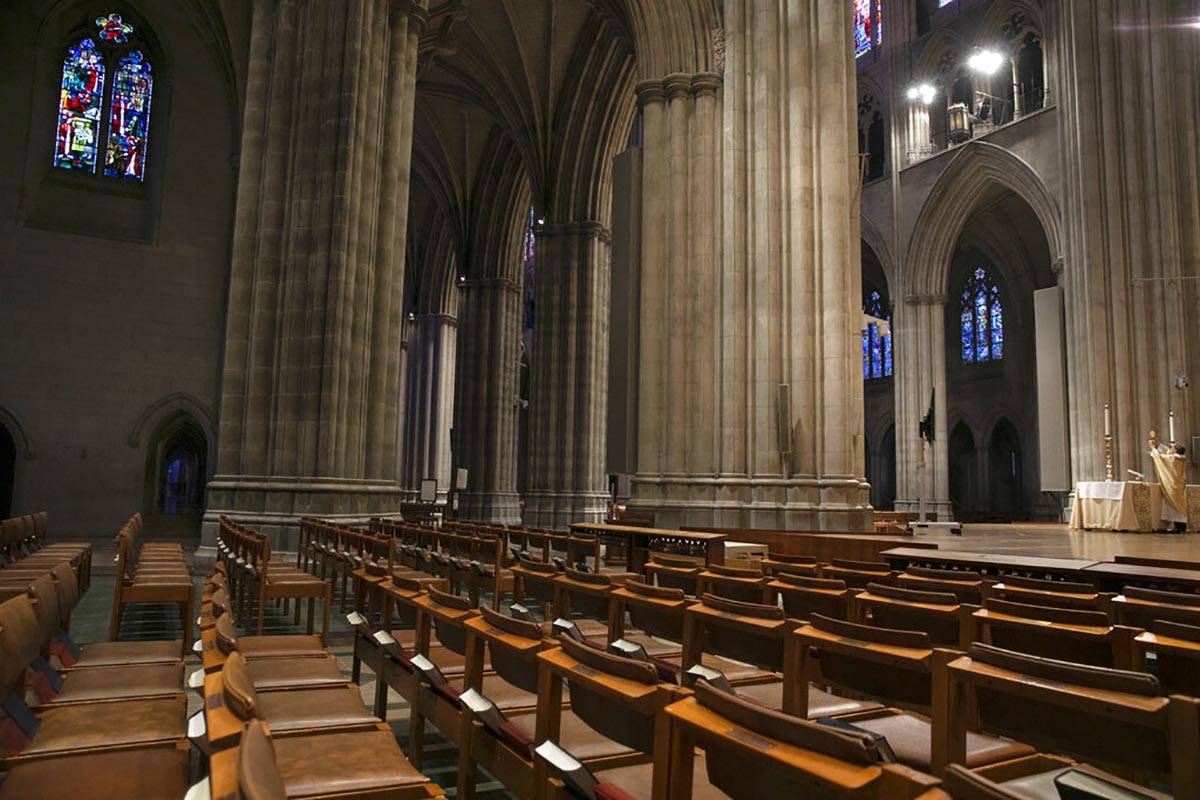 Bishop Mariann Edgar Budde, of the Episcopal Diocese of Washington, far right, holds up a commu ...