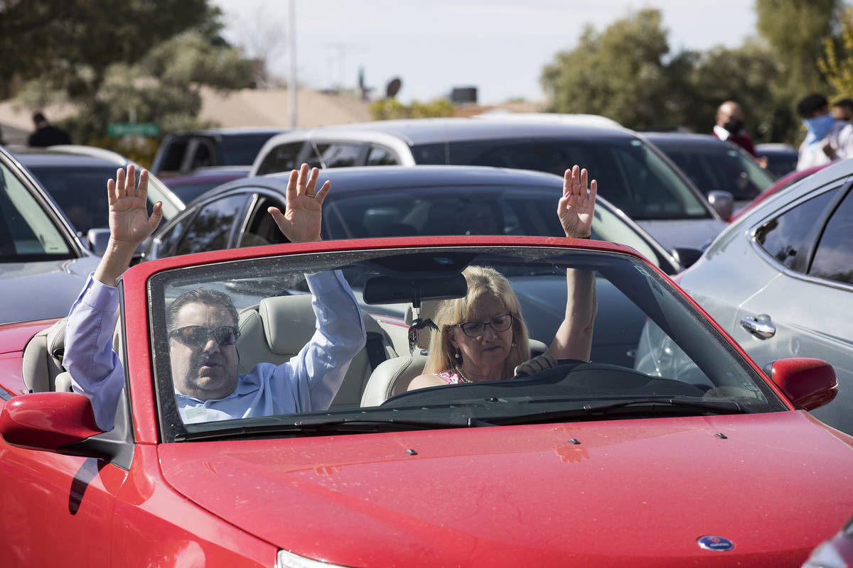 David Howard and his wife Tina Howard worship from their car at an Easter service in the parkin ...