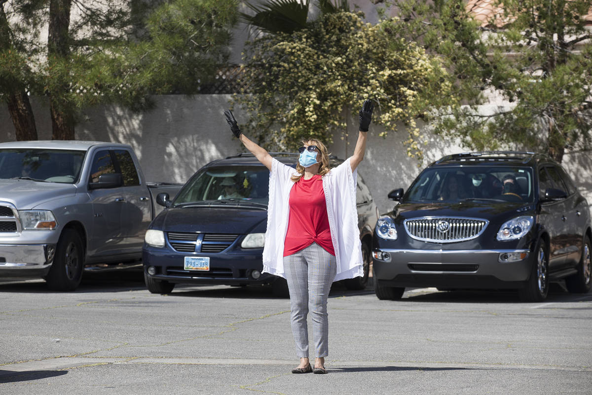 Usher Della Frank worships alongside guests in their cars at an Easter service in the parking l ...