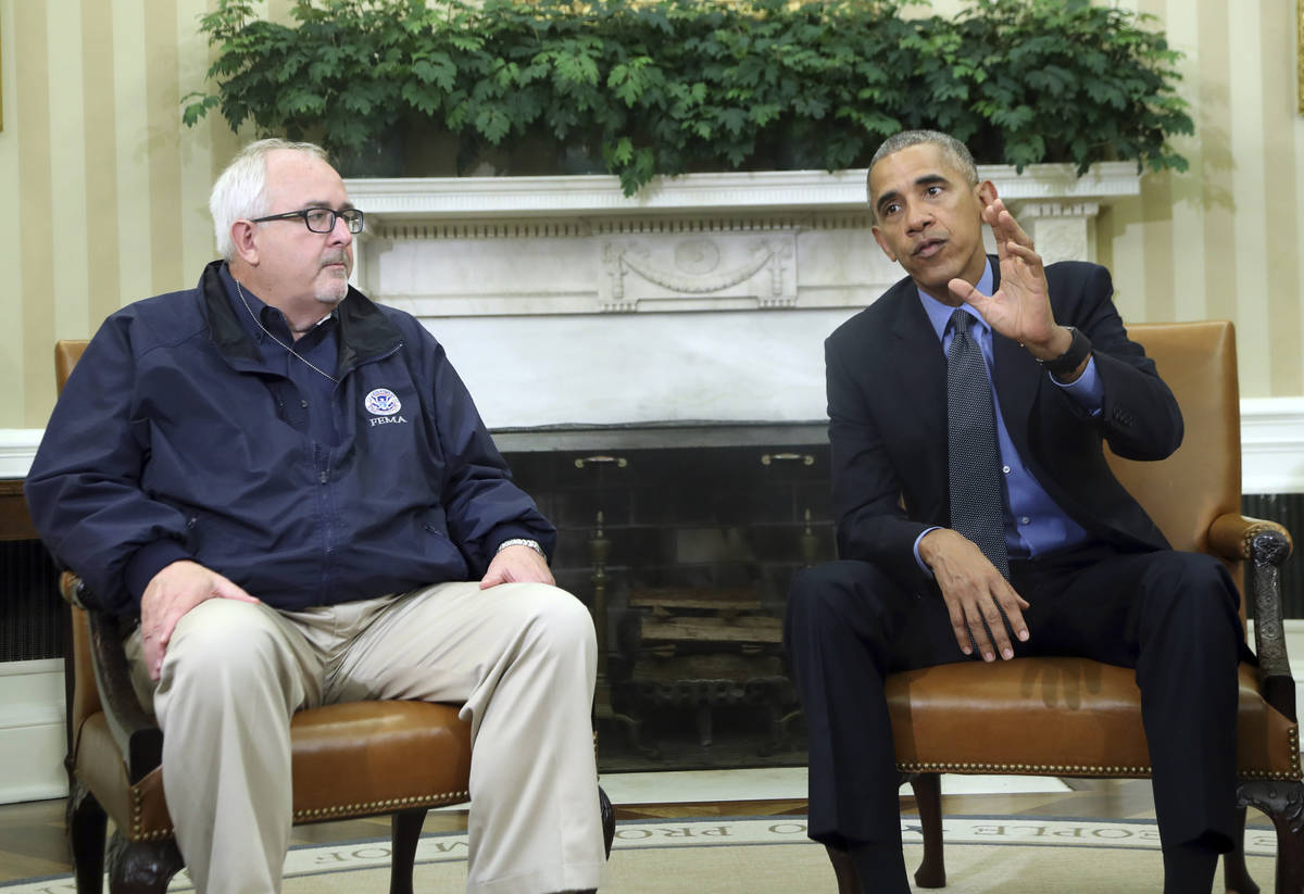 FILE - In this Oct. 7, 2016, file photo, President Barack Obama with FEMA Administrator Craig F ...